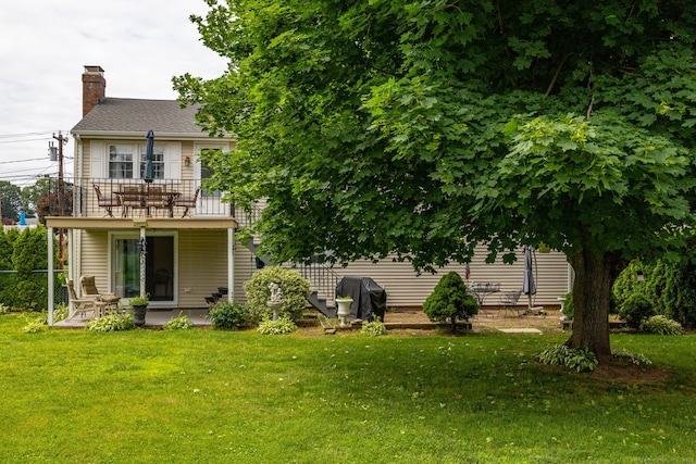 100 Chestnut Rd, Newington, CT 06111 - rear view of house with a balcony, a chimney, a yard, and a patio