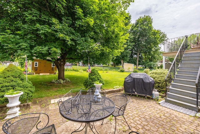 100 Chestnut Rd, Newington, CT 06111 - view of patio / terrace with stairway, grilling area, outdoor dining space, and a storage unit
