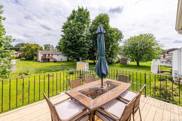 100 Chestnut Rd, Newington, CT 06111 - deck with outdoor dining area, a storage unit, and a yard