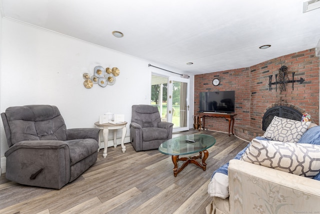 100 Chestnut Rd, Newington, CT 06111 - living area with wood finished floors, a baseboard heating unit, a brick fireplace, and ornamental molding