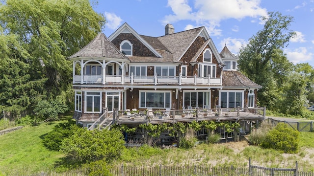 1410 S Pine Creek Rd, Fairfield, CT 06824 - view of front of home with a balcony, a chimney, and a deck