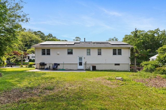 107 Carroll Rd, Hamden, CT 06517 - rear view of property featuring roof mounted solar panels, a yard, and a patio area