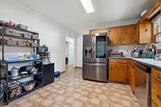 107 Carroll Rd, Hamden, CT 06517 - kitchen featuring stainless steel appliances, brown cabinets, and light countertops