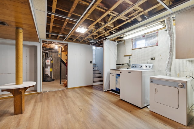 107 Carroll Rd, Hamden, CT 06517 - below grade area with gas water heater, independent washer and dryer, light wood finished floors, and stairway
