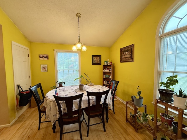 175 Berlin Ave Apt 31, Southington, CT 06489 - dining room with lofted ceiling, light wood-type flooring, healthy amount of natural light, a chandelier, and a textured ceiling