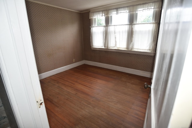 190 Victoria Rd, Hartford, CT 06114 - spare room featuring wallpapered walls, hardwood / wood-style floors, and ornamental molding