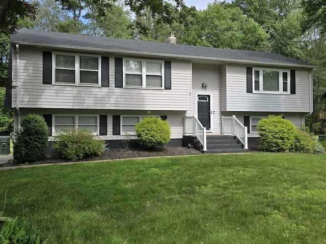 77 Hartz Ln, East Hartford, CT 06118 - bi-level home with a chimney and a front yard