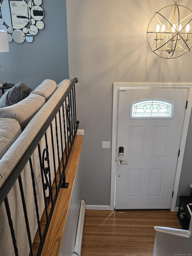 77 Hartz Ln, East Hartford, CT 06118 - foyer entrance with a baseboard heating unit, wood finished floors, and a chandelier