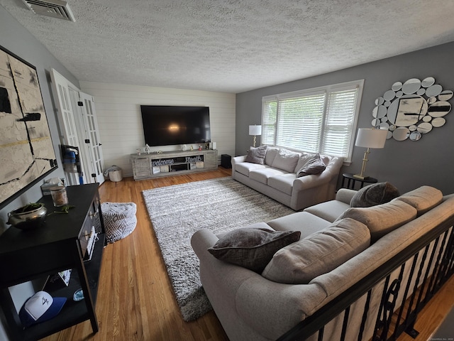 77 Hartz Ln, East Hartford, CT 06118 - living room featuring a textured ceiling and wood finished floors