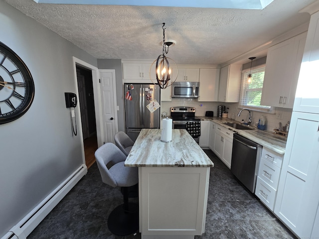 77 Hartz Ln, East Hartford, CT 06118 - kitchen with stainless steel appliances, baseboard heating, a center island, white cabinets, and a textured ceiling