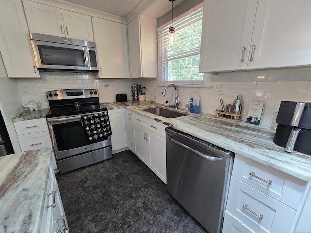 77 Hartz Ln, East Hartford, CT 06118 - kitchen featuring stainless steel appliances, white cabinetry, backsplash, and light stone countertops