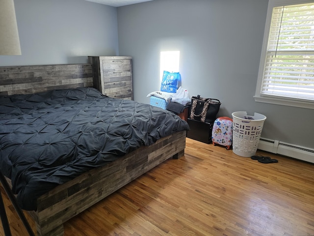 77 Hartz Ln, East Hartford, CT 06118 - bedroom with wood finished floors and a baseboard radiator