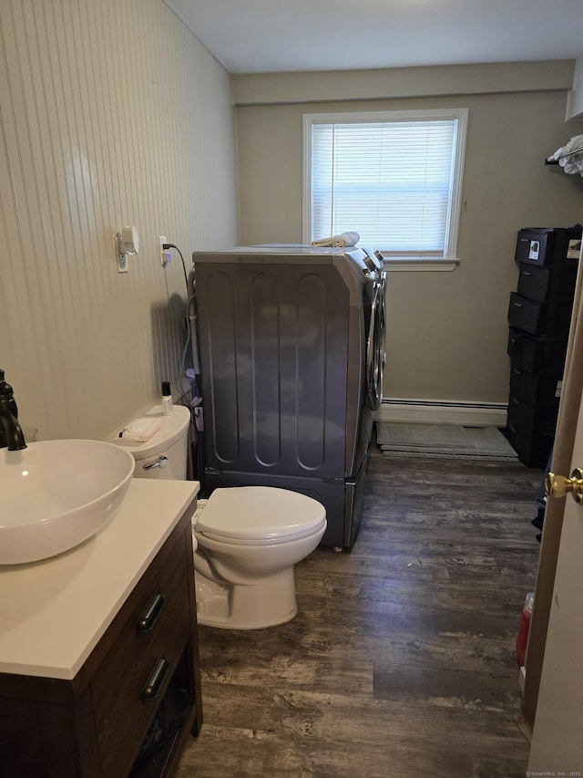 77 Hartz Ln, East Hartford, CT 06118 - bathroom with independent washer and dryer, wood finished floors, baseboard heating, and vanity