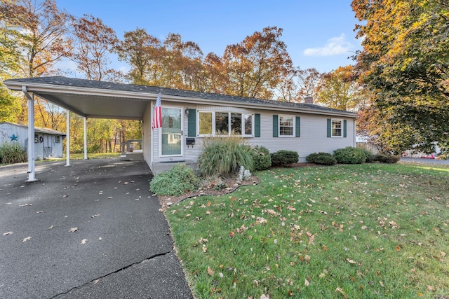 46 Jackson Rd, Enfield, CT 06082 - view of front of home featuring a front yard, driveway, an attached carport, and a chimney