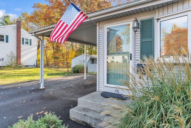 46 Jackson Rd, Enfield, CT 06082 - view of exterior entry with asphalt driveway and an attached carport