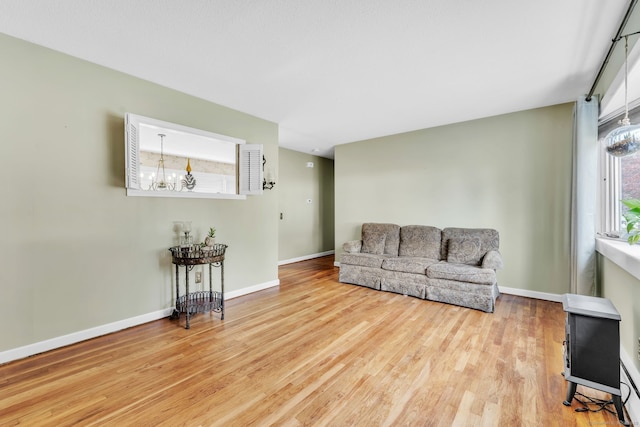 46 Jackson Rd, Enfield, CT 06082 - living area with healthy amount of natural light, wood finished floors, and a chandelier
