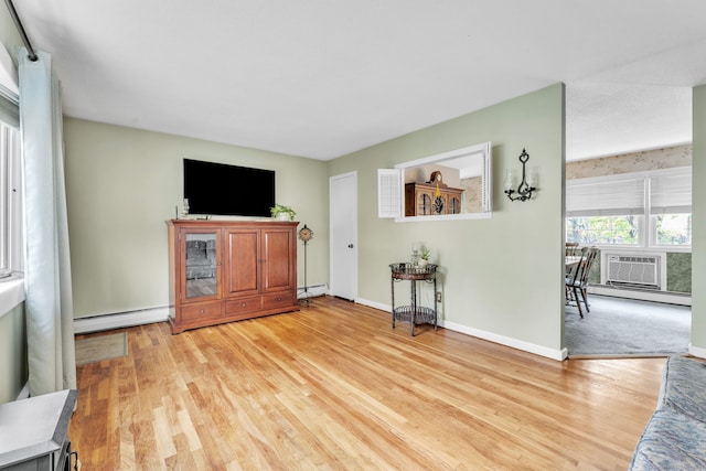 46 Jackson Rd, Enfield, CT 06082 - unfurnished living room with baseboard heating, light wood-style flooring, and a baseboard radiator