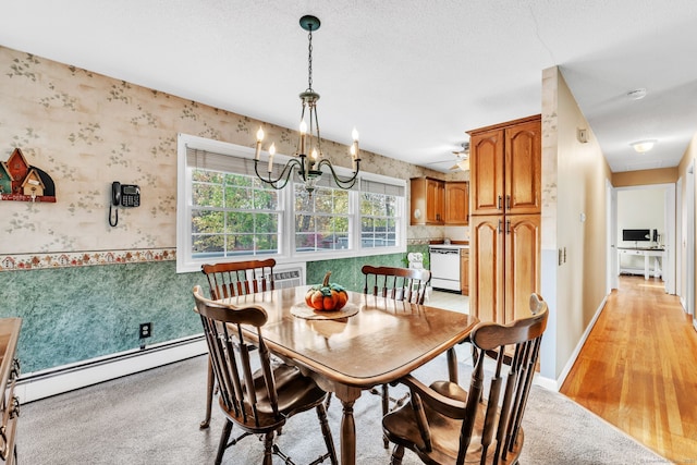 46 Jackson Rd, Enfield, CT 06082 - dining room with wallpapered walls, a chandelier, a baseboard radiator, wainscoting, and light wood-style floors