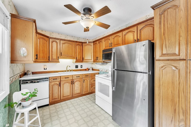 46 Jackson Rd, Enfield, CT 06082 - kitchen featuring freestanding refrigerator, white dishwasher, stove, light floors, and light countertops