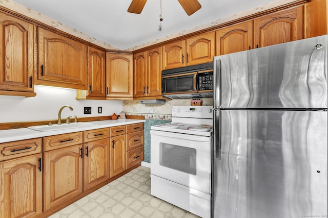 46 Jackson Rd, Enfield, CT 06082 - kitchen with freestanding refrigerator, white range with electric cooktop, black microwave, brown cabinetry, and light flooring