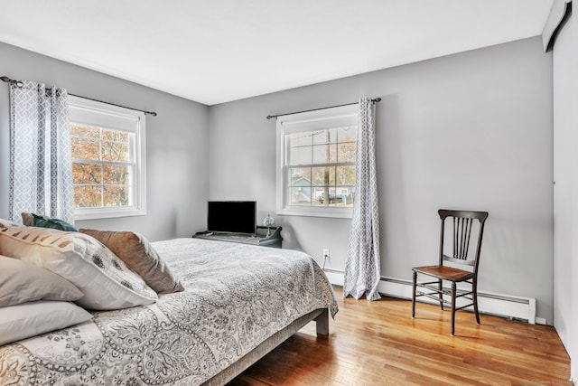 46 Jackson Rd, Enfield, CT 06082 - bedroom with a baseboard heating unit, wood finished floors, and baseboard heating