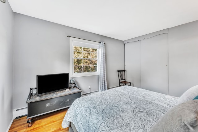 46 Jackson Rd, Enfield, CT 06082 - bedroom featuring a baseboard heating unit and wood finished floors