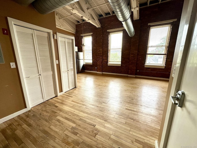 325 Lafayette St Unit 3303, Bridgeport, CT 06604 - unfurnished bedroom featuring light wood-style floors, two closets, and freestanding refrigerator