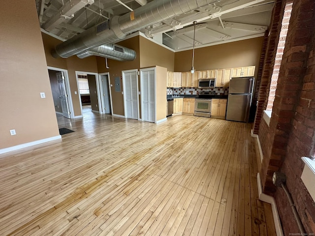 325 Lafayette St Unit 3303, Bridgeport, CT 06604 - kitchen with stainless steel appliances, a high ceiling, dark countertops, light wood-type flooring, and open floor plan