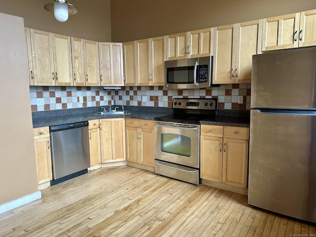 325 Lafayette St Unit 3303, Bridgeport, CT 06604 - kitchen with stainless steel appliances, light wood-style floors, light brown cabinetry, and backsplash