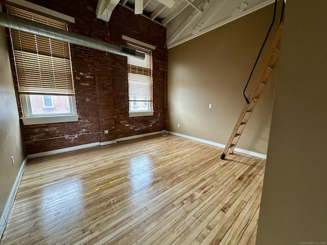 325 Lafayette St Unit 3303, Bridgeport, CT 06604 - unfurnished room with hardwood / wood-style flooring and brick wall