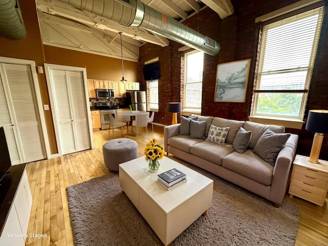 325 Lafayette St Unit 3303, Bridgeport, CT 06604 - living area with light wood finished floors, plenty of natural light, beam ceiling, and high vaulted ceiling