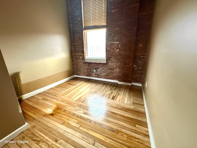 325 Lafayette St Unit 3303, Bridgeport, CT 06604 - unfurnished room featuring hardwood / wood-style flooring and brick wall