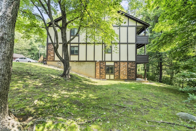 8 Carlisle Ct Unit 8, Brookfield, CT 06804 - view of home's exterior with brick siding, a yard, a balcony, and stucco siding