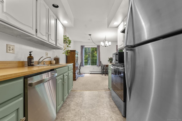 8 Carlisle Ct Unit 8, Brookfield, CT 06804 - kitchen with appliances with stainless steel finishes, green cabinetry, baseboard heating, wood counters, and a chandelier