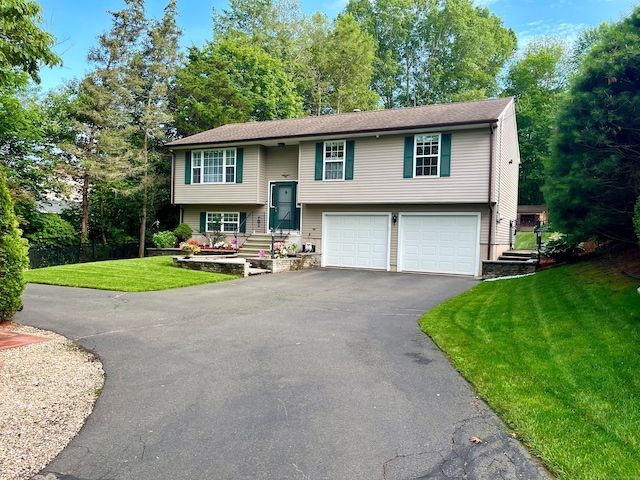168 Cooper Ln, Hamden, CT 06514 - split foyer home with driveway, a garage, and a front yard