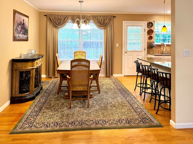 168 Cooper Ln, Hamden, CT 06514 - dining area with ornamental molding, wood finished floors, a chandelier, and healthy amount of natural light