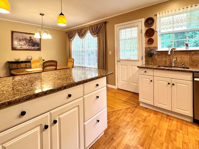168 Cooper Ln, Hamden, CT 06514 - kitchen featuring ornamental molding, light wood-style flooring, plenty of natural light, white cabinets, and hanging light fixtures