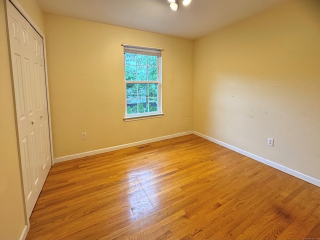 168 Cooper Ln, Hamden, CT 06514 - unfurnished bedroom featuring a closet and light wood-type flooring