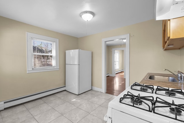 122 Derby Ave, New Haven, CT 06511 - kitchen with white appliances, a baseboard heating unit, and light tile patterned floors