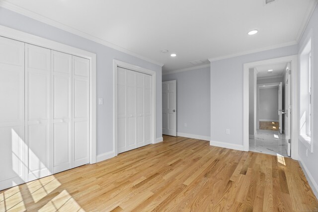 26 Meadowood Ln, Old Saybrook, CT 06475 - unfurnished bedroom featuring multiple closets, light wood-style floors, recessed lighting, and crown molding