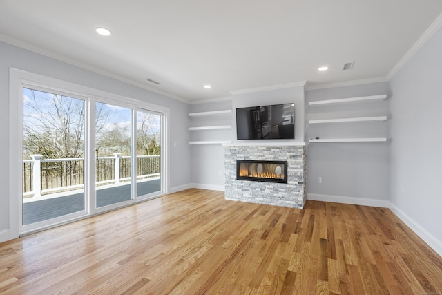 26 Meadowood Ln, Old Saybrook, CT 06475 - unfurnished living room featuring a stone fireplace, light wood-style flooring, crown molding, and recessed lighting