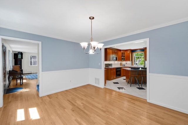 431 Fan Hill Rd, Monroe, CT 06468 - dining area with a chandelier, light wood finished floors, baseboard heating, and ornamental molding