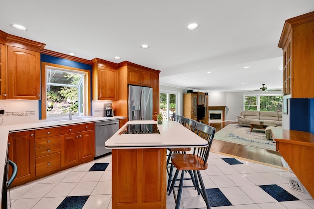 431 Fan Hill Rd, Monroe, CT 06468 - kitchen with stainless steel appliances, a breakfast bar area, recessed lighting, a fireplace, and light countertops