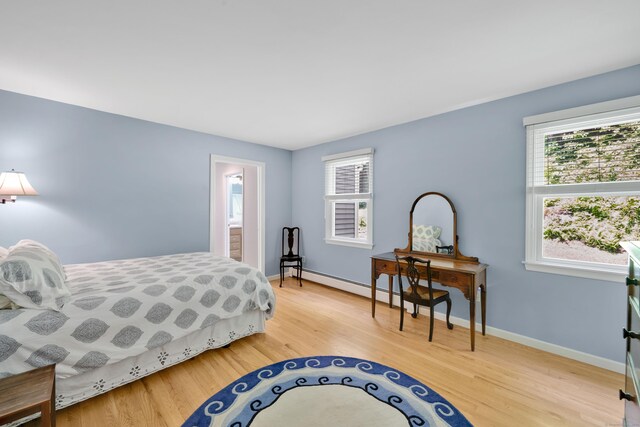431 Fan Hill Rd, Monroe, CT 06468 - bedroom with multiple windows, light wood-style floors, and a baseboard heating unit