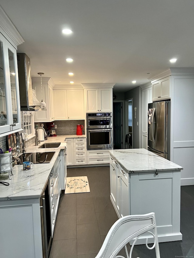 40 Great Plain Rd, Danbury, CT 06811 - kitchen with appliances with stainless steel finishes, a center island, recessed lighting, white cabinets, and backsplash