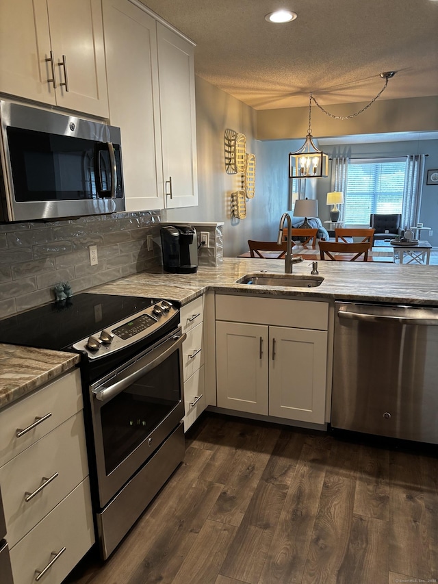 611 Overlook Path Unit 611, Southington, CT 06489 - kitchen featuring stainless steel appliances, dark wood finished floors, white cabinets, light stone counters, and recessed lighting