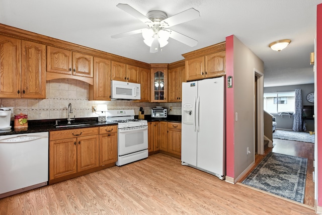 222 Sunrise Hill Rd Unit 222, Norwalk, CT 06851 - kitchen with white appliances, brown cabinets, light wood-style floors, and tasteful backsplash