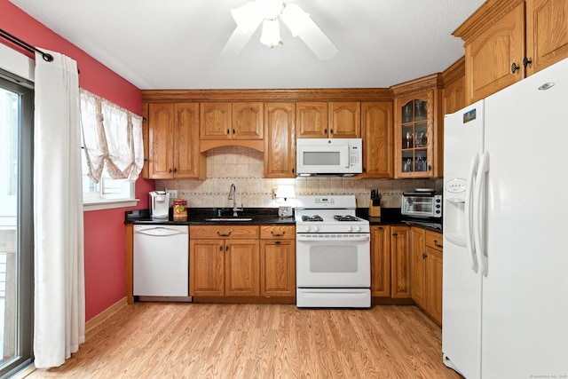 222 Sunrise Hill Rd Unit 222, Norwalk, CT 06851 - kitchen with white appliances, brown cabinets, and light wood-type flooring