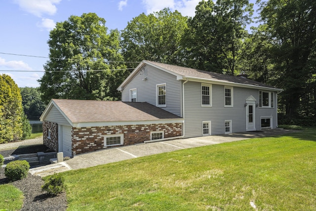 538 Quaddick Rd, Thompson, CT 06277 - view of property exterior featuring a yard, a patio area, a garage, and a shingled roof
