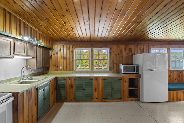 538 Quaddick Rd, Thompson, CT 06277 - kitchen featuring white appliances, wood ceiling, wood walls, light countertops, and light floors
